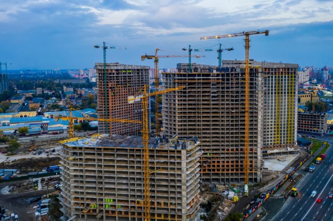 Construction site with cranes at sunset. Construction of an apartment building