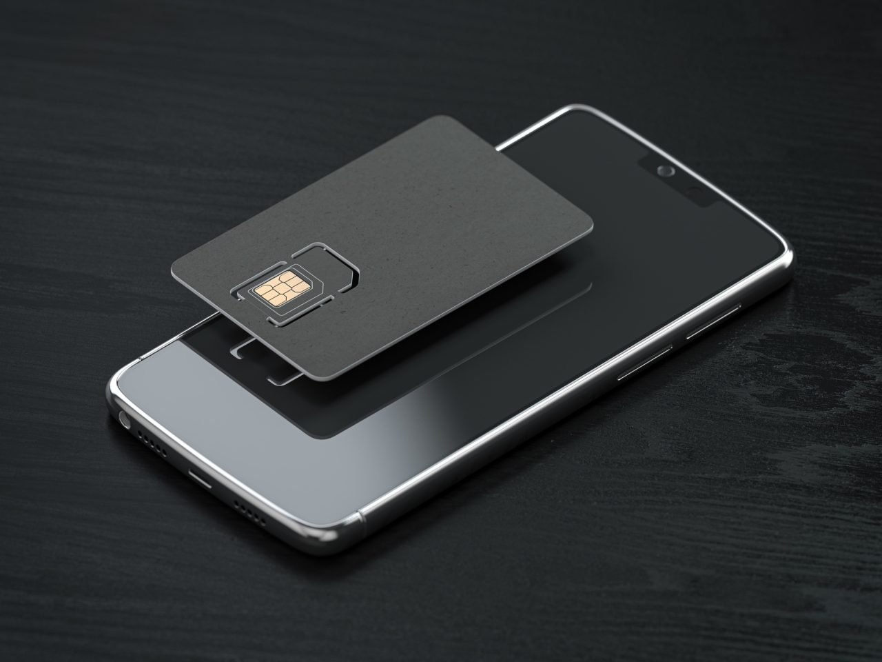 Blank black SIM smart card and mobile phone or smartphone on black table. Mock up.